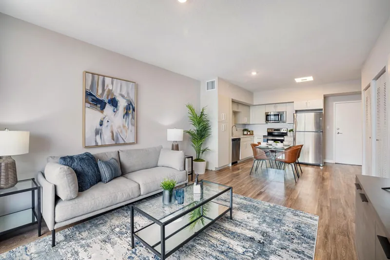 Living area flowing into the kitchen with luxury vinyl plank floors