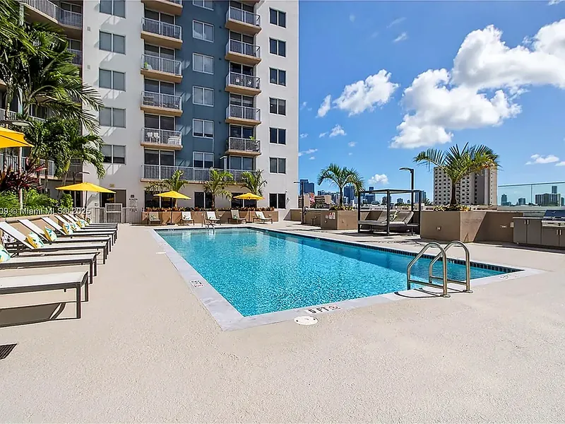 Resort-style pool deck with loungers and cabanas at Centralis Residences Miami